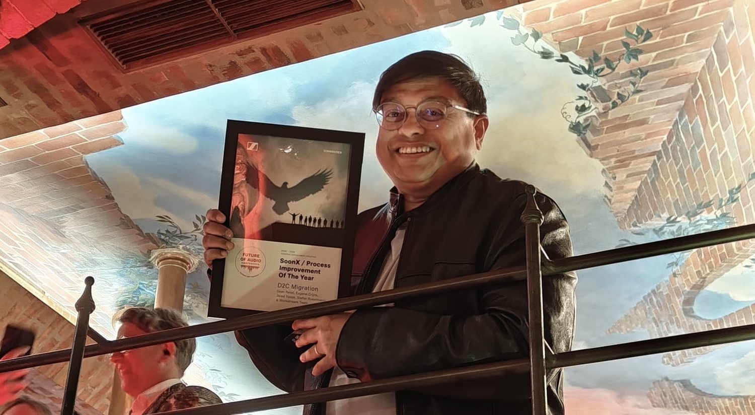Sean Rezel holding the SoonX Process Improvement of the Year award for the D2C Migration