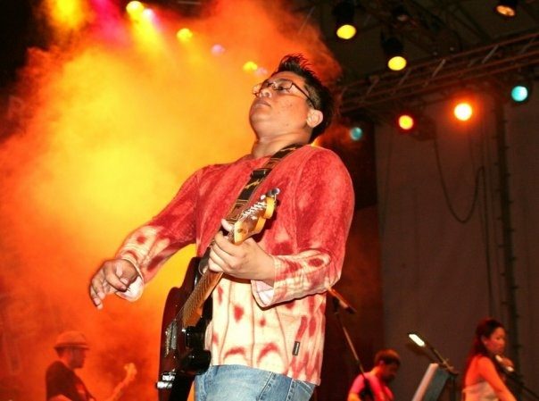 Sean playing guitar under festival lights